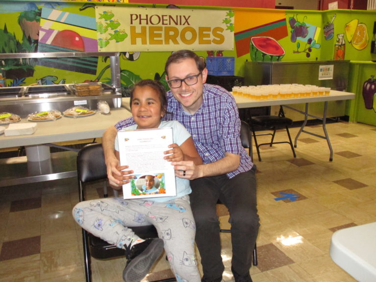 Staff/teach with student holding book