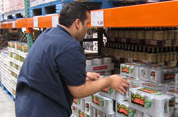 Student employee stocking shelves at warehouse store