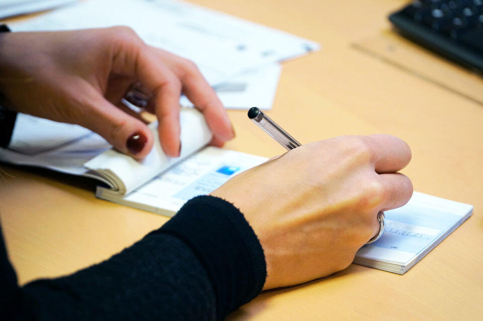 Female hand writing check