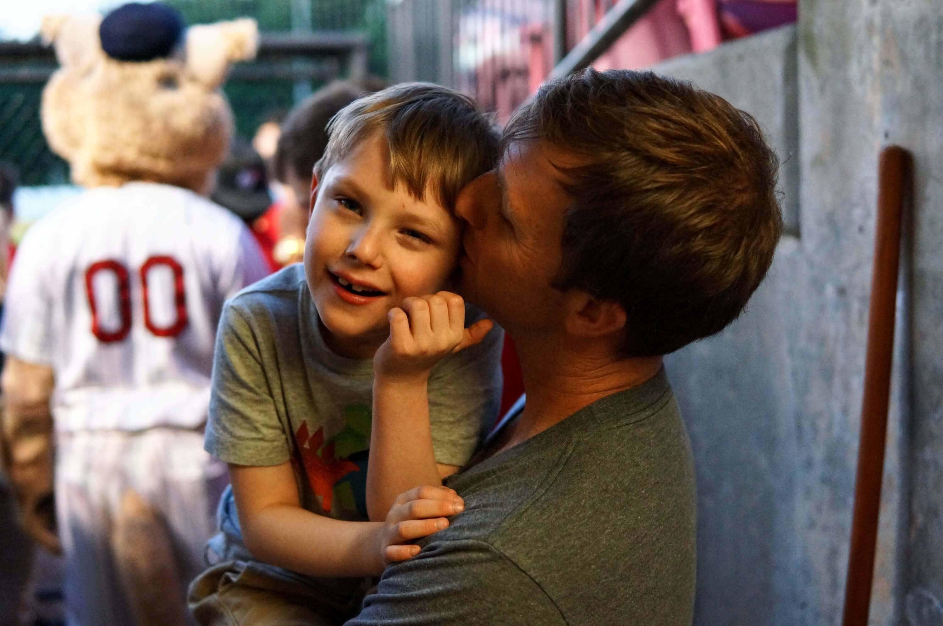 Father kissing son on cheek