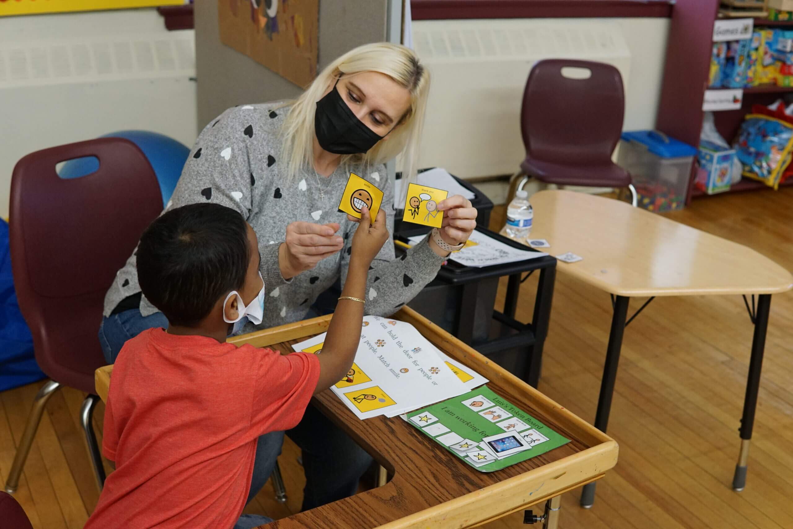 Teacher showing flash cards to student while working one on one